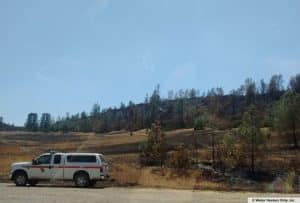 A cal fire truck outside on a dirt road.